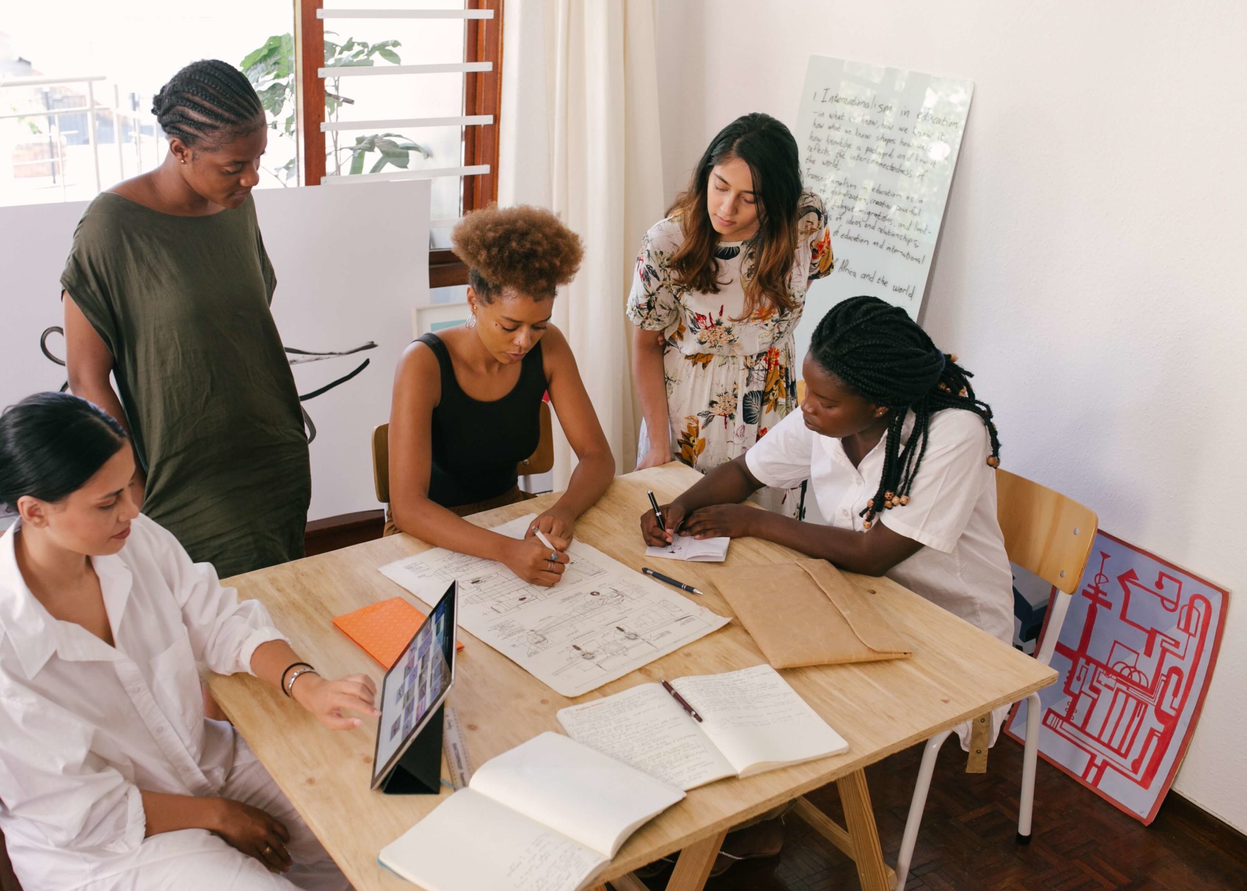 female entrepreneurs in office mapping a business strategy