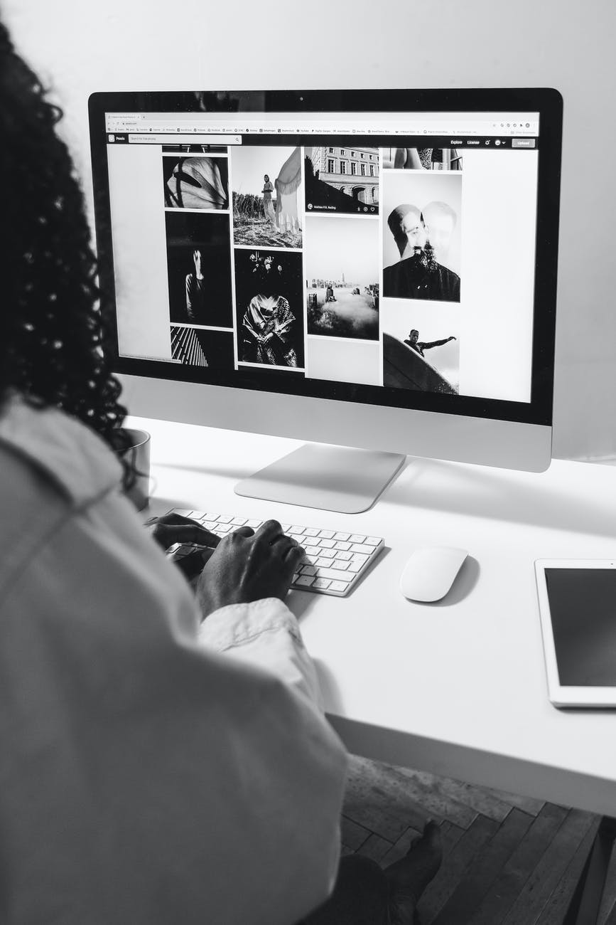 black woman typing on keyboard of modern computer